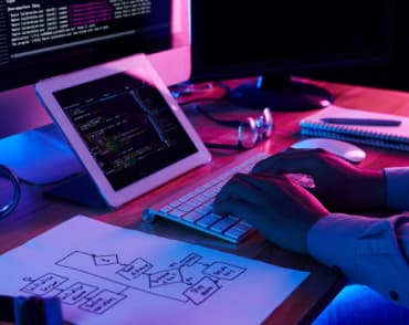 man writes code on computer